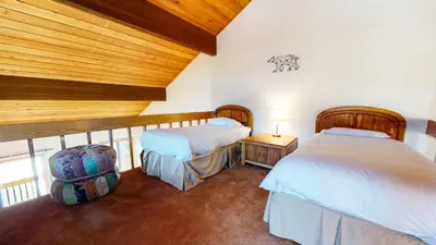 a bedroom with two beds and a wooden ceiling at Snowcreek III #448 condo in Mammoth Lakes