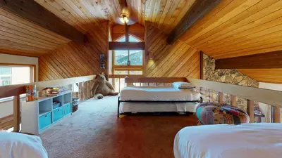 a bedroom with two beds and a teddy bear at Snowcreek III #448 condo in Mammoth Lakes
