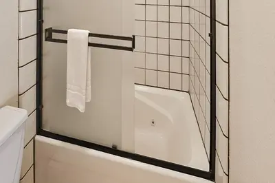 a glass shower door in a bathroom with a toilet at Tee Time Terrace in Groveland