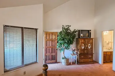 a living room with a large window and a dresser at Tee Time Terrace in Groveland
