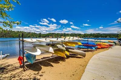 a bunch of boats are lined up on the beach at Tee Time Terrace in Groveland