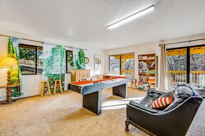 a living room with a ping pong table at Luring Lakefront Landing in Groveland