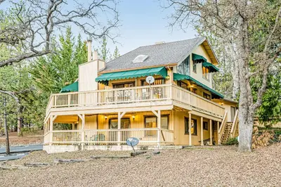 a large wooden house with a large deck at Luring Lakefront Landing in Groveland