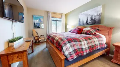 a bedroom with a bed and a desk and a television at Silver Bear #30 condo in Mammoth Lakes