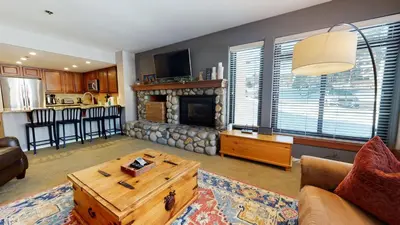 a living room with a couch and a fireplace at Silver Bear #30 condo in Mammoth Lakes