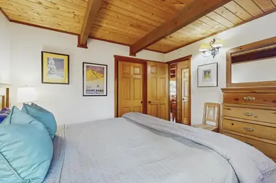 a bedroom with a bed and a wooden ceiling at Indian Hill Hush in Truckee