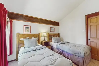 a bedroom with two beds and a door at Indian Hill Hush in Truckee
