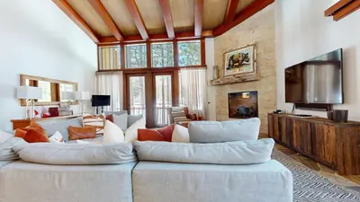 a living room with a couch and a tv at Obsidian #7 home in Mammoth Lakes