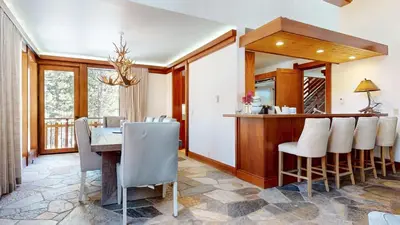 a dining room and kitchen with a table and chairs at Obsidian #7 home in Mammoth Lakes