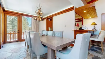 a dining room with a wooden table and chairs at Obsidian #7 home in Mammoth Lakes