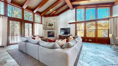 a living room with a couch with people laying on it at Obsidian #7 home in Mammoth Lakes