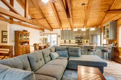 a living room with a couch and a kitchen at 1 Mi to Heavenly Resort Cozy Home with Deck! in Stateline