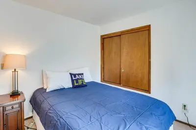 a bedroom with a blue bed and a wooden cabinet at 1 Mi to Heavenly Resort Cozy Home with Deck! in Stateline