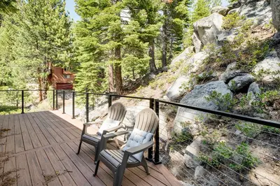 two chairs sitting on a wooden deck with trees at 1 Mi to Heavenly Resort Cozy Home with Deck! in Stateline