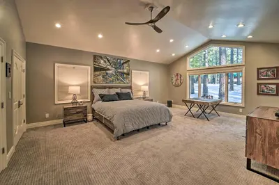 a bedroom with a bed and a ceiling fan at 4 Mi to Dtwn Truckee Tahoe Donner Home with Hot Tub in Truckee