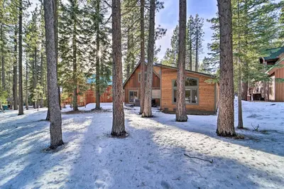 a log cabin in the woods in the snow at 4 Mi to Dtwn Truckee Tahoe Donner Home with Hot Tub in Truckee