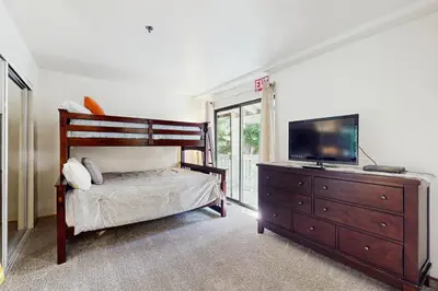 a bedroom with a bed and a tv and a dresser at South Star Pines Retreat in Stateline