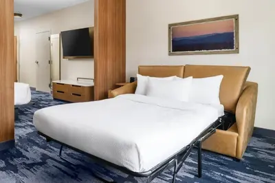 a hotel room with a bed and a television at Fairfield Inn & Suites by Marriott Oakhurst Yosemite in Oakhurst