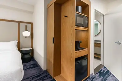 a hotel room with a bed and a tv at Fairfield Inn & Suites by Marriott Oakhurst Yosemite in Oakhurst