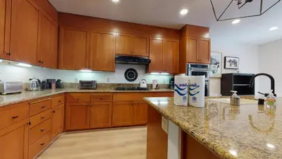 a kitchen with wooden cabinets and a granite counter top at Timbers #6 townhouse in Mammoth Lakes