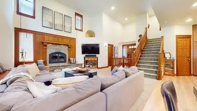 a living room with a large couch and a fireplace at Timbers #6 townhouse in Mammoth Lakes