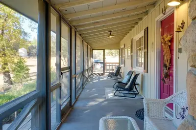 a porch with chairs and a red door at Secluded Mountain Hideaway Less Than 8 Miles to Bass Lake! in North Fork
