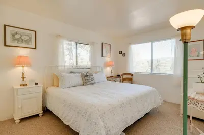 a white bedroom with a bed and two windows at Secluded Mountain Hideaway Less Than 8 Miles to Bass Lake! in North Fork