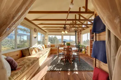 a living room with a couch and a table at Secluded Mountain Hideaway Less Than 8 Miles to Bass Lake! in North Fork