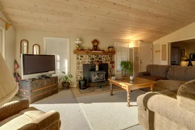 a living room with a television and a fireplace at Secluded Mountain Hideaway Less Than 8 Miles to Bass Lake! in North Fork