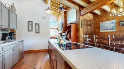 a kitchen with white counter tops and wooden ceilings at Rainbow Villas #1 condo in Mammoth Lakes
