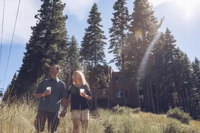 a man and a woman standing in a field at Modern 1 bedroom in Ski Trails condo in Kingswood Estates