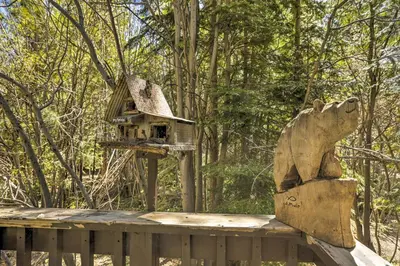 a bird house sitting on top of a wooden deck at 3 Mi to Lake Tahoe Quiet Incline Village Cabin! in Incline Village