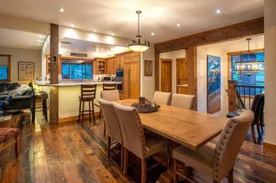 a dining room and kitchen with a wooden table and chairs at 4 Mi to Diamond Peak Ski Resort Gem with Hot Tub in Incline Village