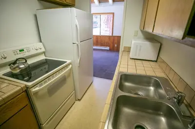 a kitchen with a sink and a white refrigerator at 1849 Condos 511 condo in Mammoth Lakes