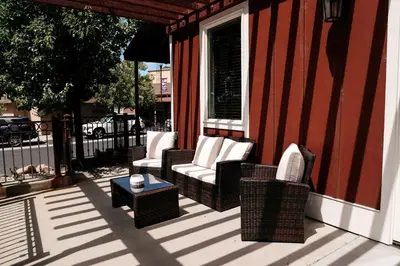 two wicker chairs and a table on a porch at Gateway Hotel, Trademark Collection by Wyndham in Copper Cove Subdivision