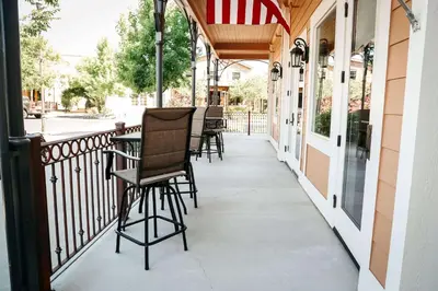 a porch with chairs and an american flag at Gateway Hotel, Trademark Collection by Wyndham in Copper Cove Subdivision