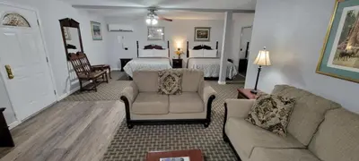 a living room with a couch and a bedroom at 5th Street Inn in Mariposa