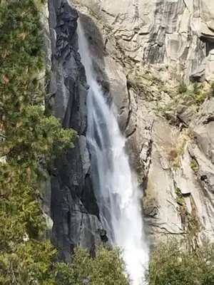 a waterfall on the side of a rocky mountain at 5th Street Inn in Mariposa