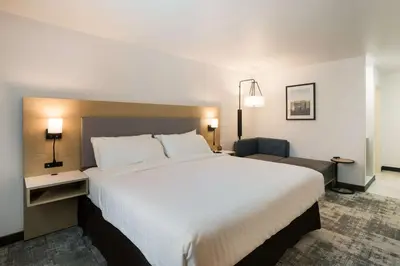 a hotel room with a large bed and a chair at Best Western Colfax in Colfax