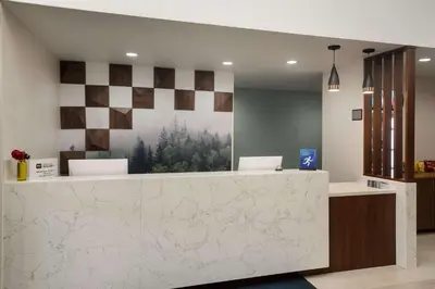 a lobby with a reception counter with a painting on the wall at Best Western Colfax in Colfax