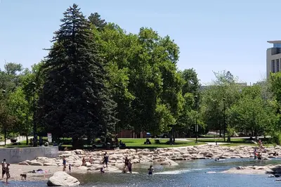a group of people on a beach near a river at Ski, Shop and Explore Walkable Midtown Reno Oasis! in Reno