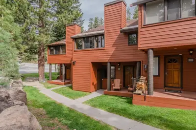 a wooden house with a porch and a lawn at Helios 11N in Mammoth Lakes