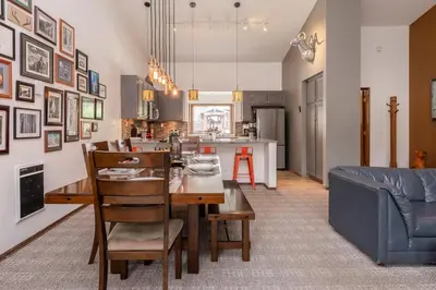 a dining room and kitchen with a table and a couch at Helios 11N in Mammoth Lakes