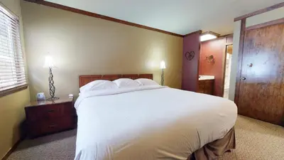a bedroom with a large white bed and a window at Mammoth Estates 3 Bdrm Condos - Walking Distance to The Village Gondola Station in Mammoth Lakes