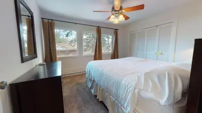 a bedroom with a bed and a ceiling fan at Mammoth Estates 3 Bdrm Condos - Walking Distance to The Village Gondola Station in Mammoth Lakes