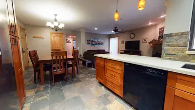 a kitchen and dining room with a table and chairs at Mammoth Estates 2 Bedroom Condos Near Mammoth Village in Mammoth Lakes