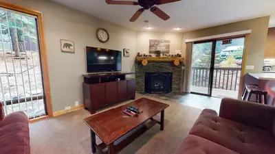 a living room with a tv and a fireplace at Mammoth Estates 2 Bedroom Condos Near Mammoth Village in Mammoth Lakes