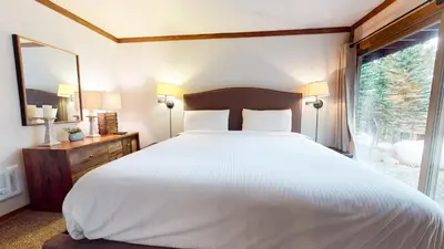 a bedroom with a large white bed and a window at 2 Bedroom Condos at Mammoth Estates - Near Mammoth Village! in Mammoth Lakes