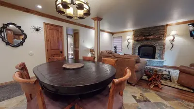 a living room with a table and a fireplace at Mammoth Estates Deluxe 2 Bedroom Condos in Mammoth Lakes