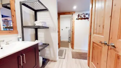 a bathroom with a sink and a mirror at Mammoth Estates Studio Condos 2 Blocks from The Village Gondola Station in Mammoth Lakes